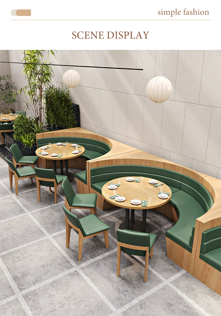 Modern curved wooden dining bench with green cushions in a stylish restaurant setting, paired with round wooden tables and matching green chairs.