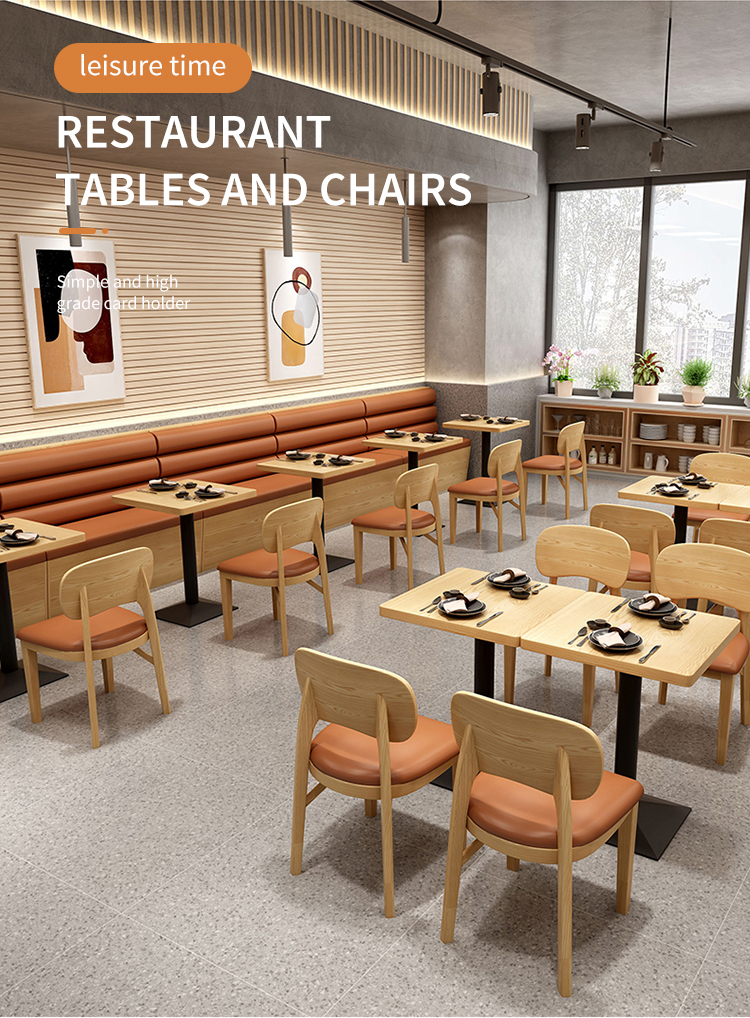 A contemporary restaurant interior featuring light wood tables and chairs with orange leather cushions. 