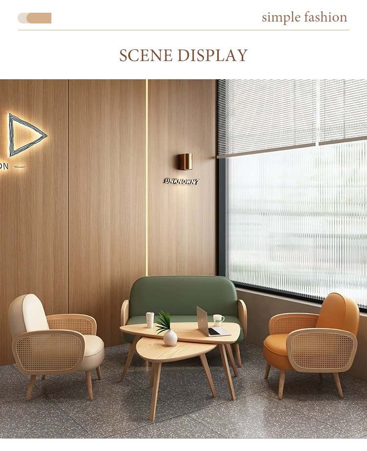 A cozy lounge area featuring rattan armchairs, a green sofa, and wooden tables. Perfect for relaxing or working in a modern and minimalist space with natural light