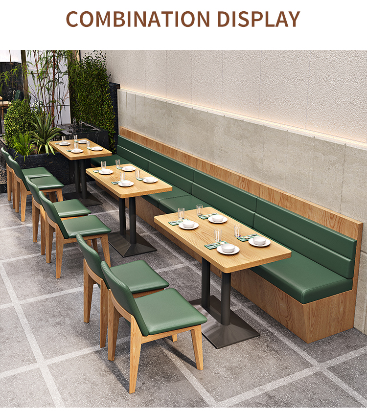 Green upholstered booth seating and wooden chairs arranged in a modern restaurant setting.