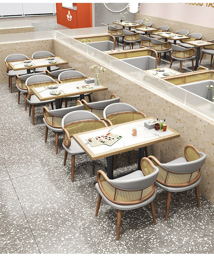 Overhead view of a restaurant with marble-top tables and stylish rattan chairs arranged in a modern dining area