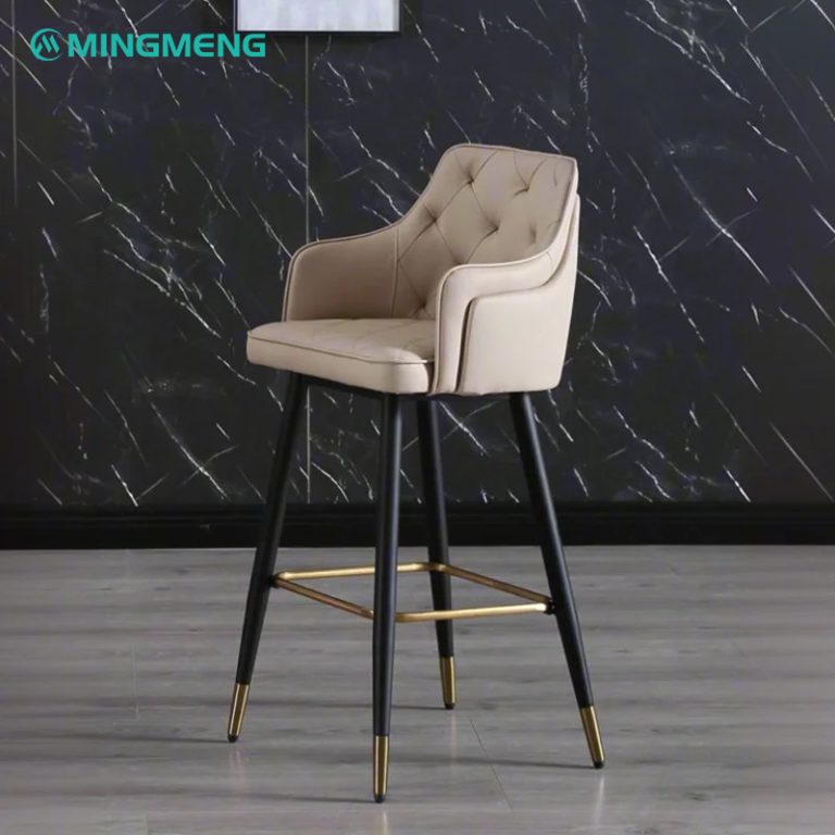 White leather barstool with brown backrest, gold metal base, and modern design featuring sleek lines.